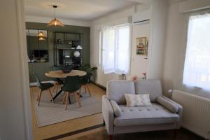 a living room with a couch and a table at Douce escale - Climatisation in Marzy