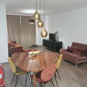 a living room with a wooden table and chairs at VALERIA-DREAMS Maestro luna 5,2º in Zaragoza