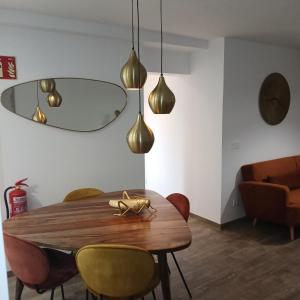 a dining room with a wooden table and chairs at VALERIA-DREAMS Maestro luna 5,2º in Zaragoza