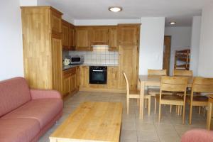 a living room with a couch and a table at Plein Ciel VA 032 - MOUNTAIN apartment 6 pers in Veysonnaz