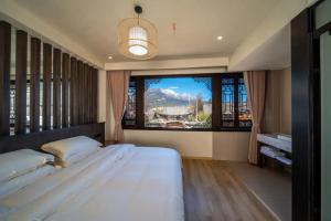 Postel nebo postele na pokoji v ubytování Dawnscape Courtyard 辰曦别苑