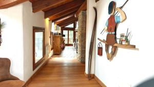 a hallway of a house with a painting on the wall at Hostdomus - La Maison di Billy in Sestriere