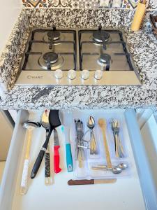 a kitchen counter with a stove and some utensils at La Casa Luminosa 5 in Larache