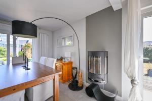 a dining room with a table and a television at Le Boucard - Terrasse - Proche plage in Saint-Nazaire
