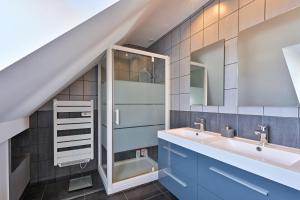 a bathroom with a sink and a mirror at Le Boucard - Terrasse - Proche plage in Saint-Nazaire +18 photos