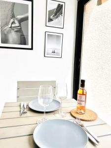 a table with two glasses and a bottle of wine at BEACH WALK Climatisé piscineparkingproche mer in Bandol +32 photos