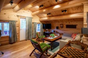 a living room in a log cabin with wooden walls at Trysilfjellet Sør 802 in Trysil