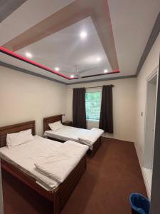 Aba-SHAH GUEST HOUSE SKARDU客房内的一张或多张床位