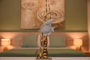 a toy fish hanging from a pole in a room at O Sole Mio in Myrties