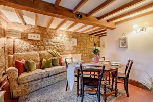 a living room with a table and a couch at Lion Cottage in Stanton in Peak