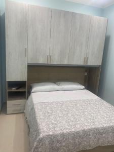 a bedroom with a bed with a large wooden headboard at Falegnameria del Conte in Montecorice
