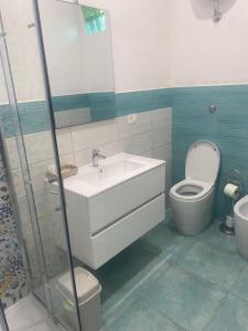 a bathroom with a sink and a toilet at Falegnameria del Conte in Montecorice