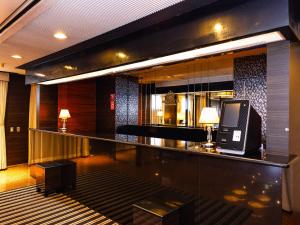 a lobby with a bar with a television on it at APA Hotel Aomori Ekihigashi in Aomori +70 photos