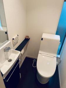 a bathroom with a white toilet and a sink at Ikebukuro池袋1stop-2min-Kitaikebukuro北池袋walk3min in Tokyo +13 photos