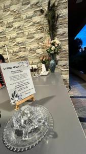 a table with a glass plate and a sign on it at Divine Resort- Bhilar in Panchgani