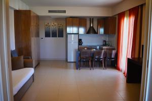 a kitchen with a couch and a table in a room at Tsokas Hotel in Finikounta