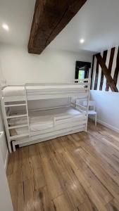 a room with white shelves and a wooden floor at Gîtes, Les Fontaines de Normandie in Saint-Julien-sur-Calonne