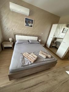 a bedroom with a bed with two pillows on it at Apartment Tuthon in Pomorie