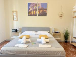 a bedroom with a large bed with towels on it at Quattro Venti city suites in Rome