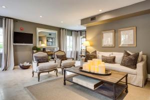 a living room with a couch and a table at Sun Harbour Boutique Hotel in Miami Beach
