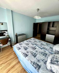 a bedroom with a bed and a desk in it at Sirena Appartment in Sveti Vlas