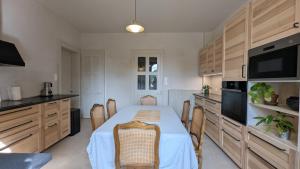 a kitchen with a table with chairs and a kitchen with at Château Foncine in Foncine-le-Bas