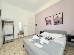 a bedroom with a large bed with towels on it at Quattro Venti city suites in Rome