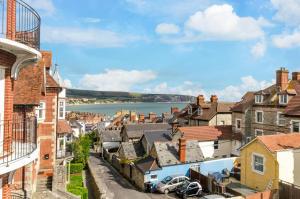 a view of a town with houses and a body of water at Flat 5 Penlu in Swanage
