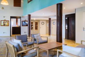 a living room with a table and chairs at Résidence Pierre & Vacances Premium Port Prestige in Antibes