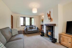 a living room with a couch and a fireplace at The Catlow in Parwich