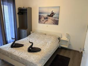 a bedroom with two black swans on a bed at Natasa apartments Krk in Vrh