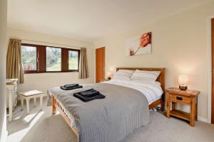 a bedroom with a large bed and a window at The Catlow in Parwich