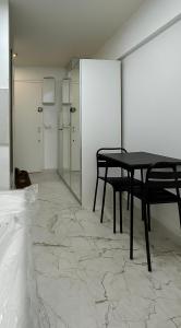 a room with a table and chairs and a mirror at Paris 16, Lux Studio - Steps from metro 9! in Paris