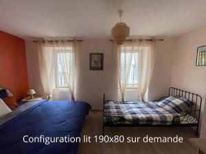 a bedroom with two beds and two windows at Au Cœur d Orgelet in Orgelet