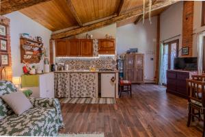 a living room with a couch and a kitchen at Casa di Cristina in Casamaggiore +31 photos