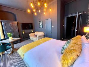 a bedroom with a large bed with a chandelier at Blue Skye Guest House 8 in Brighton & Hove
