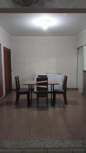 a dining room with a table and two chairs at Chácara Minerva RC casa com piscina house with pool in Rio Claro