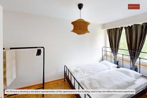 a bedroom with a bed and a chandelier at Relax with Room to Spare 3-Bedroom Zurich Stay in Zürich
