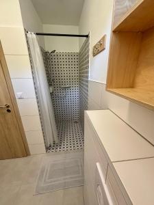 a shower with a glass door in a bathroom at el Gotel in Čadca +63 photos