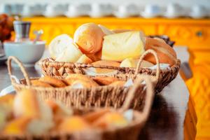 a basket of bread and butter on a table at VELINN Pousada Solar Grego in Ubatuba