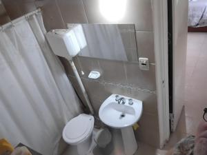 プエルト・マドリンにあるBallenatos2の白いトイレと洗面台のあるバスルーム