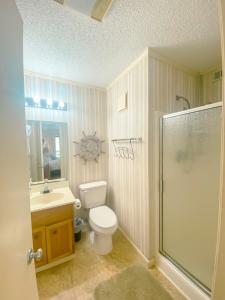 a bathroom with a toilet and a sink and a shower at Seasons In The Sun in North Myrtle Beach
