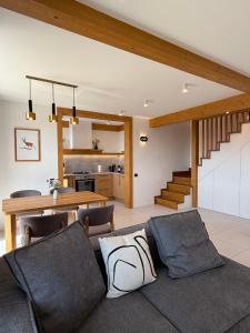 a living room with a couch and a table at Villa Bergbliss in Yablunytsya