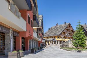 an empty street in a town with buildings at Prato Nevoso - Alben Ski Apartment - GrandMaison in Prato Nevoso +23 photos
