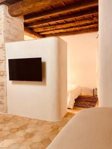 a television on a wall in a bedroom at Citabella Bastia in Bastia