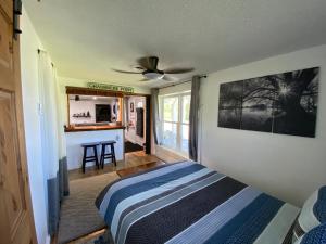 a bedroom with a bed and a ceiling fan at Our Place Up North BnB in Huntsville