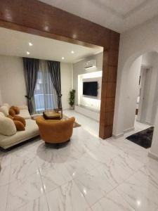 a large living room with a couch and a chair at DHB Stays Luxury Downtown Apartment 1BR 89 in Cairo