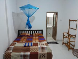 卡图纳耶克Villa 64 - Airport Transit的一间卧室配有一张蓝色遮阳伞的床