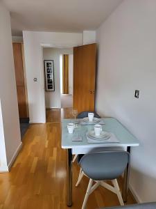a dining room with a table with two chairs and a table and a table at Stylish 2Bedroom Flat - City Centre - Near Leeds Station in Leeds