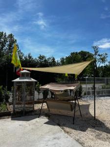 a tan tent with a table and a grill at Agri Campeggio La Passeggiata in Goito +2 photos